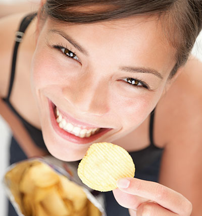 Happy employee eating chips for a snack